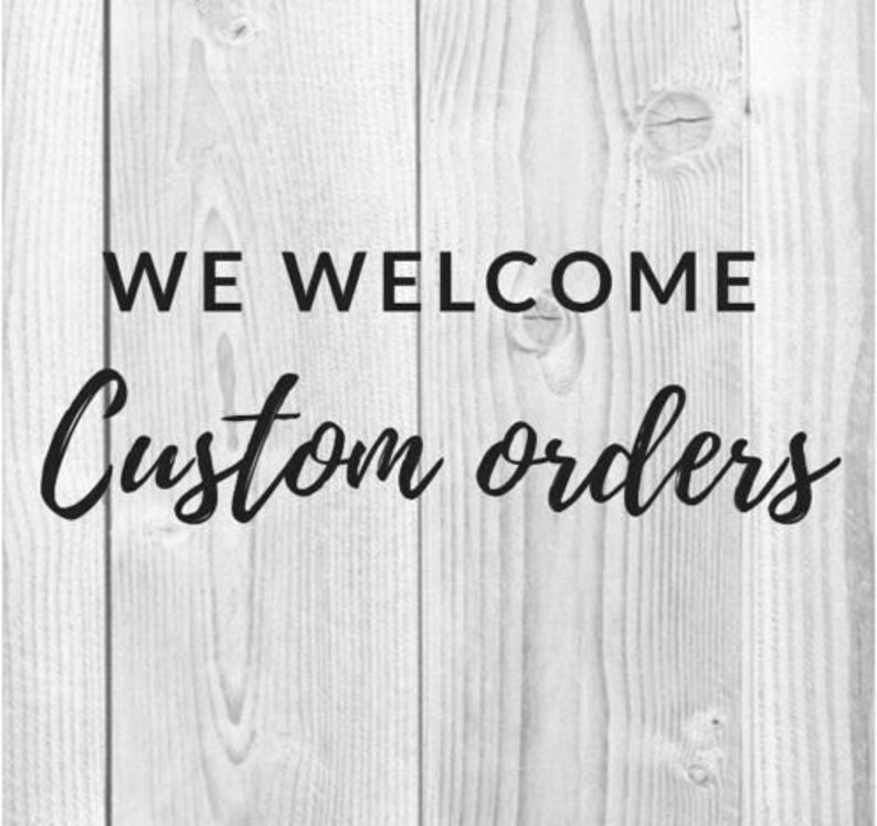 Pode incluir: Texto preto sobre um fundo de madeira branca com a frase "WE WELCOME Custom orders". O texto &eacute; uma mistura de fontes sem serifa e cursivas. O fundo tem um padr&atilde;o de gr&atilde;o de madeira vertical.