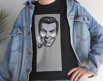 May include: A black t-shirt featuring a rectangular gray graphic of a smiling person with a pipe emitting smoke. The person is rendered in a black and white halftone dot style. The t-shirt is worn under a light blue denim jacket with metal buttons.