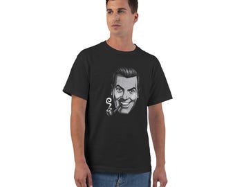 May include: A black short-sleeved t-shirt featuring a centered grayscale graphic of a smiling person with slicked-back hair holding a smoking pipe in their mouth. The design is printed on the front of the garment, which is worn with blue jeans.