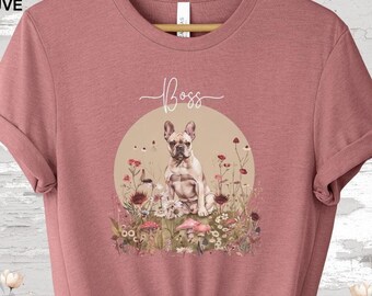 May include: Heather mauve t-shirt featuring a graphic of a French bulldog sitting in a field of flowers. The text "Boss" is written above the dog.