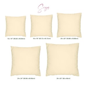 May include: Five different sizes of beige square throw pillows. The pillows are arranged in a grid pattern with the dimensions of each pillow listed below. The dimensions are listed in inches and centimeters.