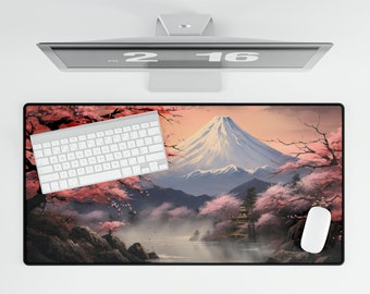 May include: A rectangular desk mat featuring a Japanese landscape with Mount Fuji, cherry blossoms, and a pagoda. A white keyboard and mouse are on the mat, with a computer monitor above.