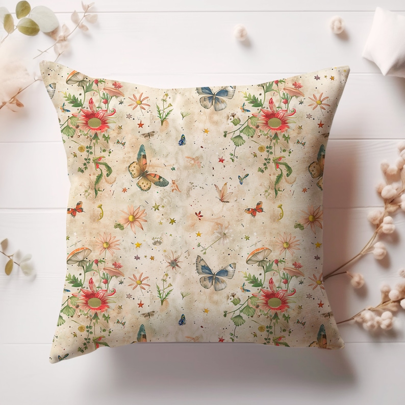 May include: A beige throw pillow with a floral and butterfly pattern. The pattern features red, orange, yellow, blue, and green colors on a cream background. The pillow has a subtle distressed look.