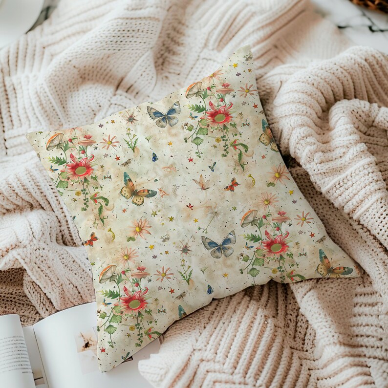 May include: A cream-colored throw pillow with a floral and butterfly pattern. The pattern features red, blue, yellow, and green butterflies and flowers on a cream background with a subtle distressed look.