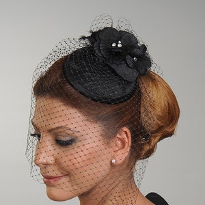 Handmade Black Floral Fascinator with Birdcage Veil, in a shape of a circle mini hat made of satin fabric. It can be preferred for weddings, cocktail parties, or as funeral or church hat.