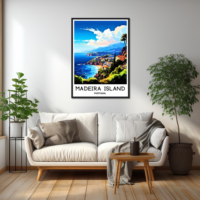 May include: A vintage travel poster featuring a colorful illustration of a coastal town on Madeira Island, Portugal. The poster has a blue sky with white clouds, a blue ocean, green hills, and a town with red-roofed buildings. The text on the poster reads "Madeira Island, Portugal."