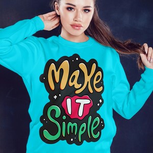 May include: A turquoise blue sweatshirt with a black, green, yellow, and red graphic print that says "Make it Simple".