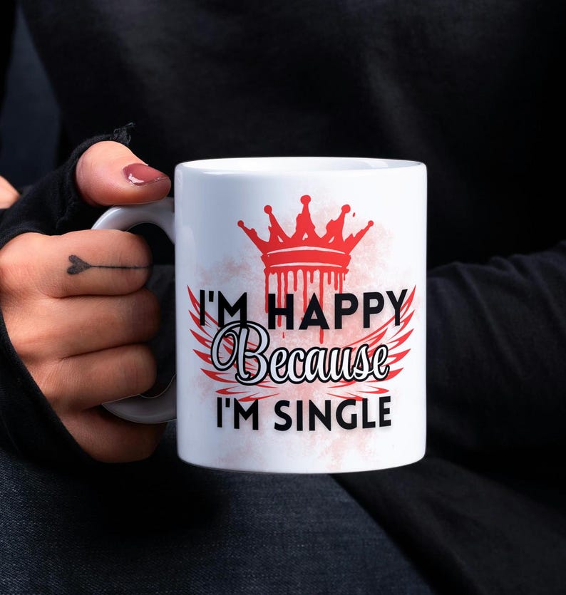 May include: White ceramic mug with a red crown and black text that reads "I'm Happy Because I'm Single".