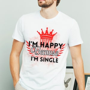 May include: White t-shirt with a red crown and wings, and the text "I'm Happy Because I'm Single".
