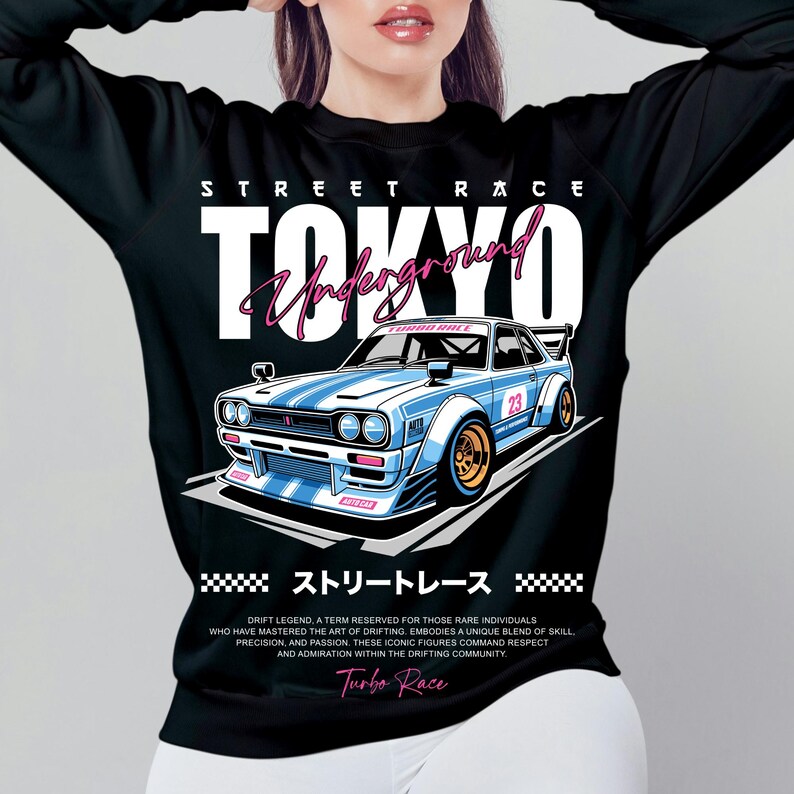 Puede incluir: Camiseta negra de manga larga con un dise&ntilde;o de coche de carreras azul y blanco, el texto "TOKYO Underground" y "Turbo Race". El dise&ntilde;o incluye texto japon&eacute;s y el n&uacute;mero 23. El dise&ntilde;o de la camiseta est&aacute; inspirado en las carreras callejeras.