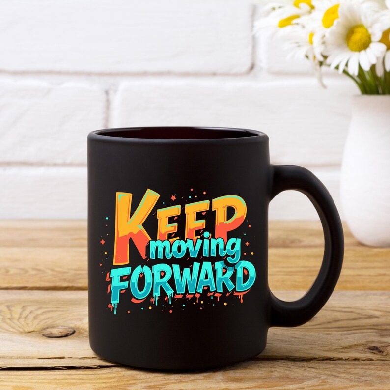 May include: Black ceramic coffee mug with a colorful graphic that says "Keep moving forward".