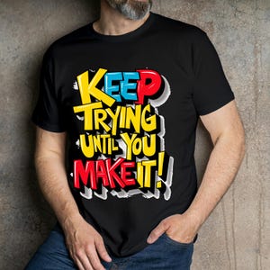 May include: Black t-shirt with a colorful graphic that says "Keep Trying Until You Make It!"