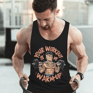 May include: Black tank top with the text "Your Workout Is My Warm-Up" in orange and white. The graphic features a cartoon weightlifter. The tank top is sleeveless and made of a soft material.