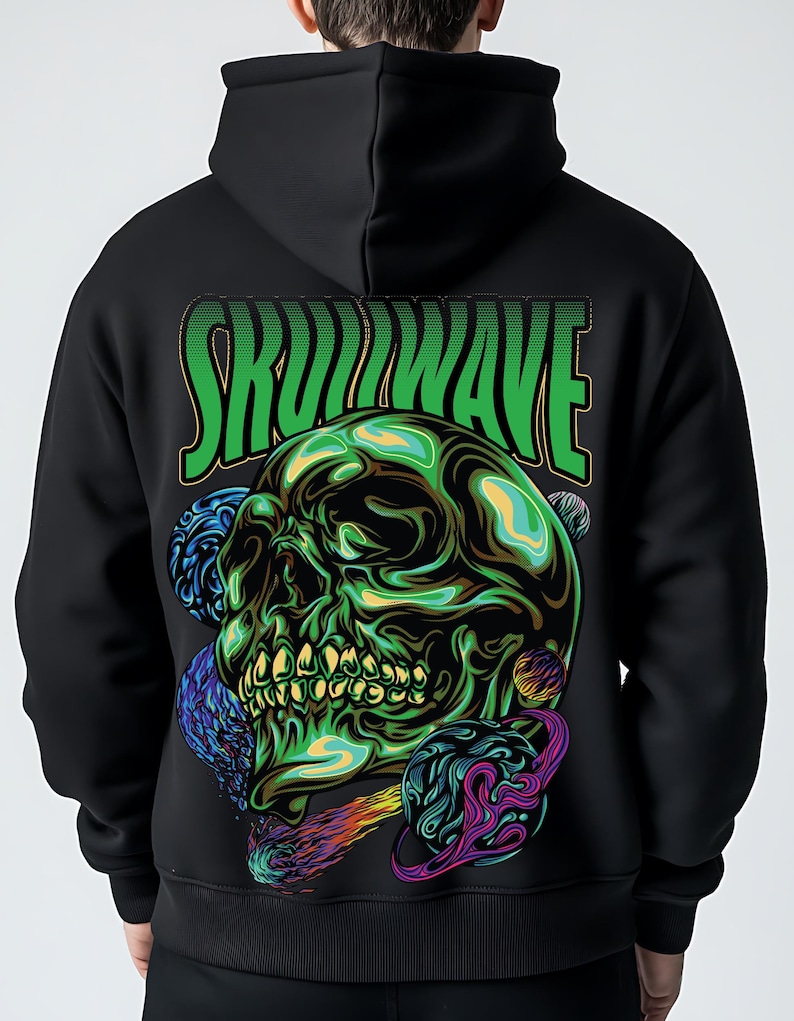 May include: A black hoodie featuring a large graphic on the back. The design displays a green, metallic-looking skull surrounded by colorful planets and a comet. Above the skull, the text SKULLWAVE is printed in bold, green, stylized letters.
