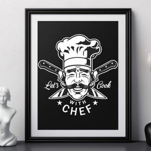 May include: Black framed print featuring a smiling chef with a large mustache and chef's hat. The image includes crossed knives and the text "Let's Cook with Chef" in white. The artwork is displayed on a black surface.