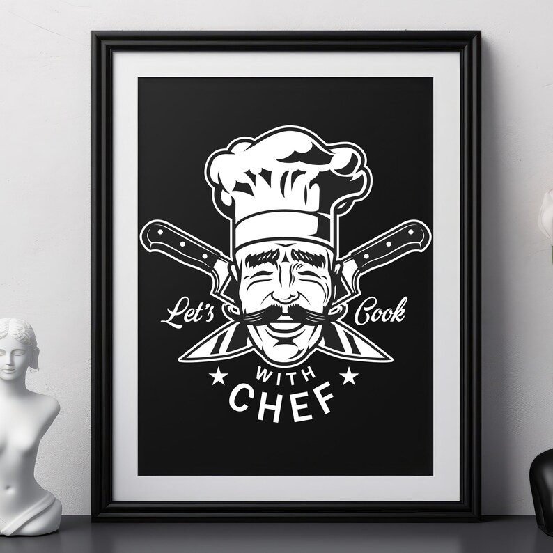 May include: Black framed print featuring a smiling chef with a large mustache and chef's hat. The image includes crossed knives and the text "Let's Cook with Chef" in white. The artwork is displayed on a black surface.