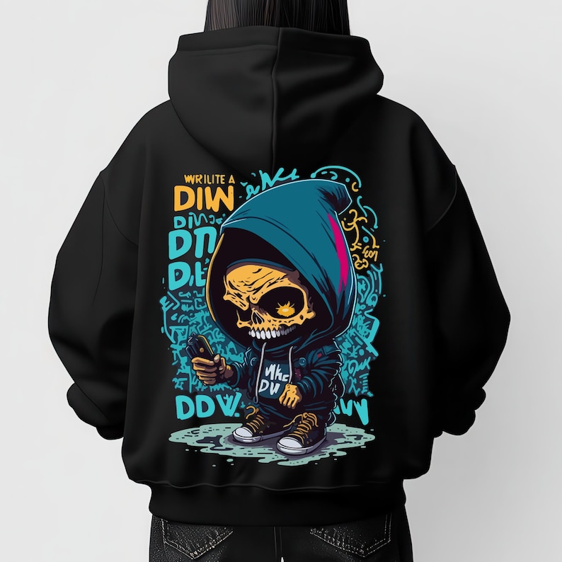 May include: A black hooded sweatshirt featuring a graphic on the back of a cartoon skull character wearing a blue hoodie and sneakers. The design includes yellow and blue graffiti-style text and abstract shapes, with the text "WRILITE A DIW" visible.