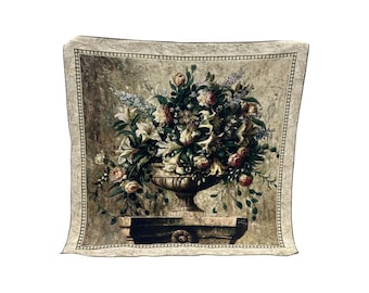 May include: A square tapestry featuring a detailed floral still life. The artwork depicts a large arrangement of flowers in a decorative urn, with roses, lilies, and other blooms in shades of white, pink, and yellow.