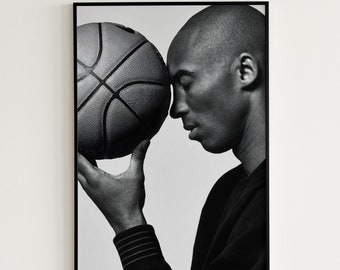 May include: Black and white photo of a person holding a basketball. The person is looking down at the ball with their eyes closed.