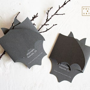 May include: Two black bat-shaped invitations with white text. The text reads "Washington Roseville, CA" and "Please respond by October 25th".