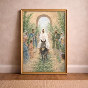 Puede incluir: Una pintura enmarcada representa una escena religiosa con una figura vestida de blanco montada en un burro, rodeada de personas que sostienen ramas de palma. La obra de arte está situada dentro de un arco, enmarcada en oro y expuesta sobre un suelo de madera.