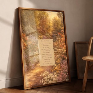 May include: A rectangular framed wall art piece featuring a vibrant garden landscape with a dirt path, lush trees, and colorful flowers. Centered on the image is a parchment-style overlay with the text: This One Thing, Yet hope returns when I remember this one thing; The Lord's unfailing love and mercy will continue, fresh as the morning, as sure as the sunrise. The Lord is all I have, and so in him I put my hope. - Lamentations 3:21-24.
