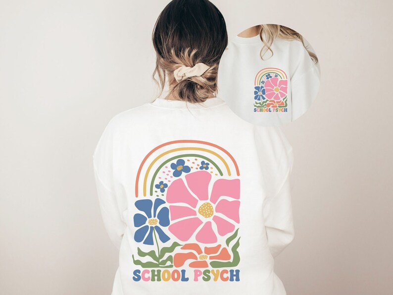 May include: White long-sleeved sweatshirt with a rainbow and flower design on the back. The text "SCHOOL PSYCH" is printed below the design.