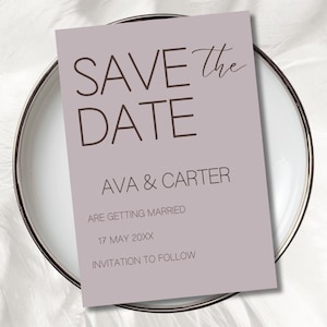 May include: A mauve-colored save-the-date card with the text "SAVE the DATE" in a mix of fonts. The card also includes the names "AVA & CARTER", the date "17 MAY 20XX", and the phrase "INVITATION TO FOLLOW". The card is placed on a white plate.