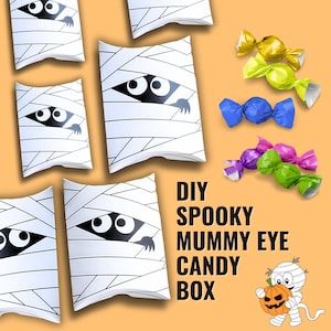 May include: White mummy-themed candy boxes with black eyes and a hand peeking out. Colorful wrapped candies in yellow, green, blue, purple, and pink are scattered around the boxes. Text reads "DIY Spooky Mummy Eye Candy Box."