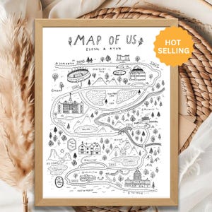 May include: A framed black and white line art print titled MAP OF US ELENA & RYAN. The illustration features a whimsical map with various landmarks, roads, trees, mountains, and bodies of water labeled with names like LEMINGTON, AUBURN, and HOUSTON.