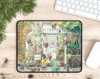 May include: A colorful mousepad featuring a cartoon illustration of Pokemon characters in front of a shop with a green awning. The characters include Bulbasaur, Pikachu, and a Treecko. The shop is surrounded by plants and flowers.