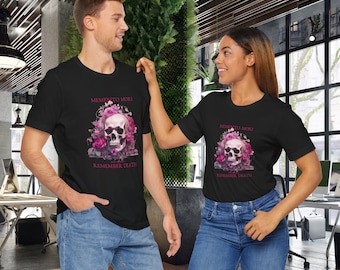 May include: Two black t-shirts with a pink skull and floral design. The text on the shirts reads "Memento Mori, Remember Death."