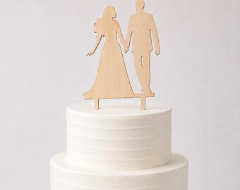 cake topper of newlyweds looking at each other