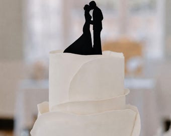 Elegant wedding cake topper with a minimal kiss