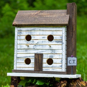 Charming Wooden Martin Box Cabin with Stained Roof and Distressed Texture