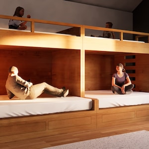 May include: A wooden bunk bed with two sets of bunks. The top bunks have a wooden railing. The bottom bunks have a white mattress. Two people are sitting on the bottom bunks and two people are sitting on the top bunks.