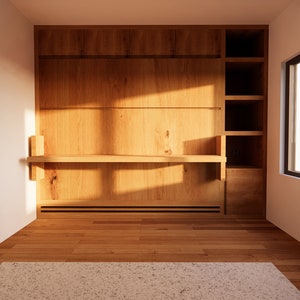 K&ouml;nnte beinhalten: Eine Holzwand-Einheit mit Regalen und einer langen, schmalen Arbeitsplatte. Die Einheit ist aus hellbraunem Holz gefertigt und hat eine nat&uuml;rliche Oberfl&auml;che. Die Wand-Einheit befindet sich in einem Raum mit einer wei&szlig;en Wand und einem Fenster mit schwarzem Rahmen.