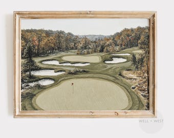 May include: A framed print of a watercolor painting depicting a golf course with green grass, sand traps, and trees. A red flag marks the hole on the green.
