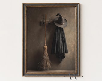 May include: Framed artwork featuring a witch's hat, coat, and broom. The hat and coat hang on a wooden rack, while the broom leans against a wooden shelf. The artwork has a vintage, sepia-toned aesthetic, with a dark frame.