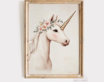 May include: A framed watercolour print of a unicorn. The unicorn has a golden horn and is adorned with a floral crown of pink and yellow flowers. The artwork is in a gold-coloured wooden frame.