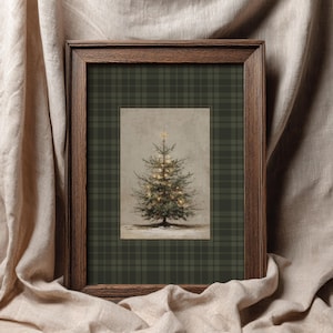 May include: A framed print featuring a Christmas tree with twinkling lights and a star on top. The artwork is set against a plaid background in a dark green color, encased in a brown wooden frame. The overall aesthetic is rustic and festive.