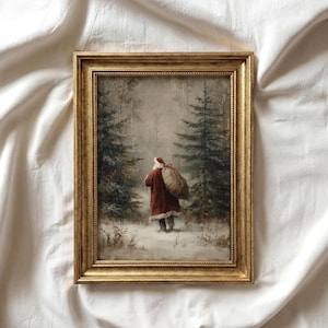 May include: A framed wall art print featuring a painting of a figure in a red coat and hat carrying a large tan sack through a snowy forest with evergreen trees. The artwork is enclosed in a decorative, ornate gold-colored rectangular frame.