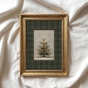 May include: A rectangular wall art piece in a distressed gold frame featuring a centered illustration of a lit Christmas tree against a light background, set within a dark green and black plaid matting that fills the entire frame border.