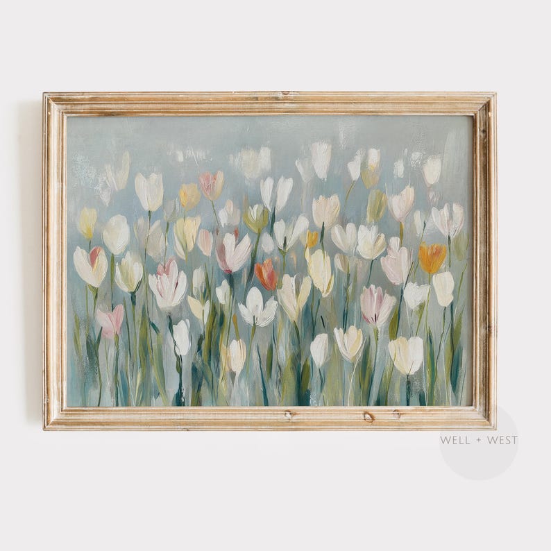 Puede incluir: Una impresi&oacute;n de arte mural horizontal enmarcada que presenta una pintura impresionista de tulipanes blancos, crema y naranja suave sobre un fondo verde salvia apagado. La obra est&aacute; en un marco de madera clara con el texto WELL + WEST.