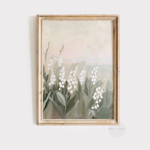 May include: A framed painting of white lily of the valley flowers in a field with a soft, pastel background.