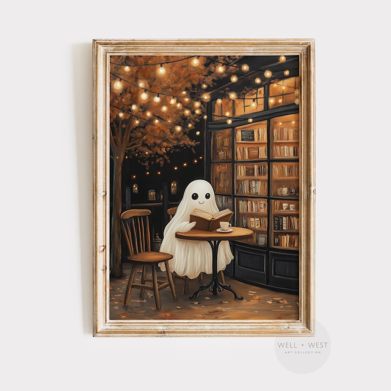 May include: A framed print depicts a friendly ghost reading a book at a cafe table. The scene is set at night, with warm lighting from string lights and a cozy bookstore backdrop. A cup of coffee sits on the table.