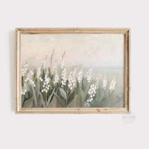 May include: A framed painting of white lily of the valley flowers in a field. The artwork has a soft, muted colour palette with shades of green, white, and beige. The frame is a distressed gold colour.