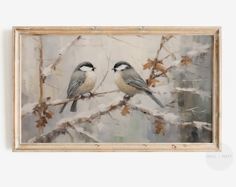 May include: A framed painting of two birds perched on a snowy branch. The birds are gray and white with brown accents. The background is a soft blue and white, with hints of brown and gold.