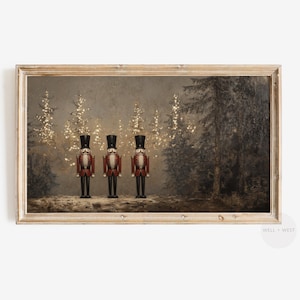 May include: Three red and black nutcracker figurines stand in a row in front of a snowy forest scene. The forest is lit with twinkling lights and the nutcrackers are wearing black hats and have white faces.