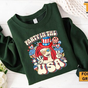 a green shirt with a picture of a girl in a top hat